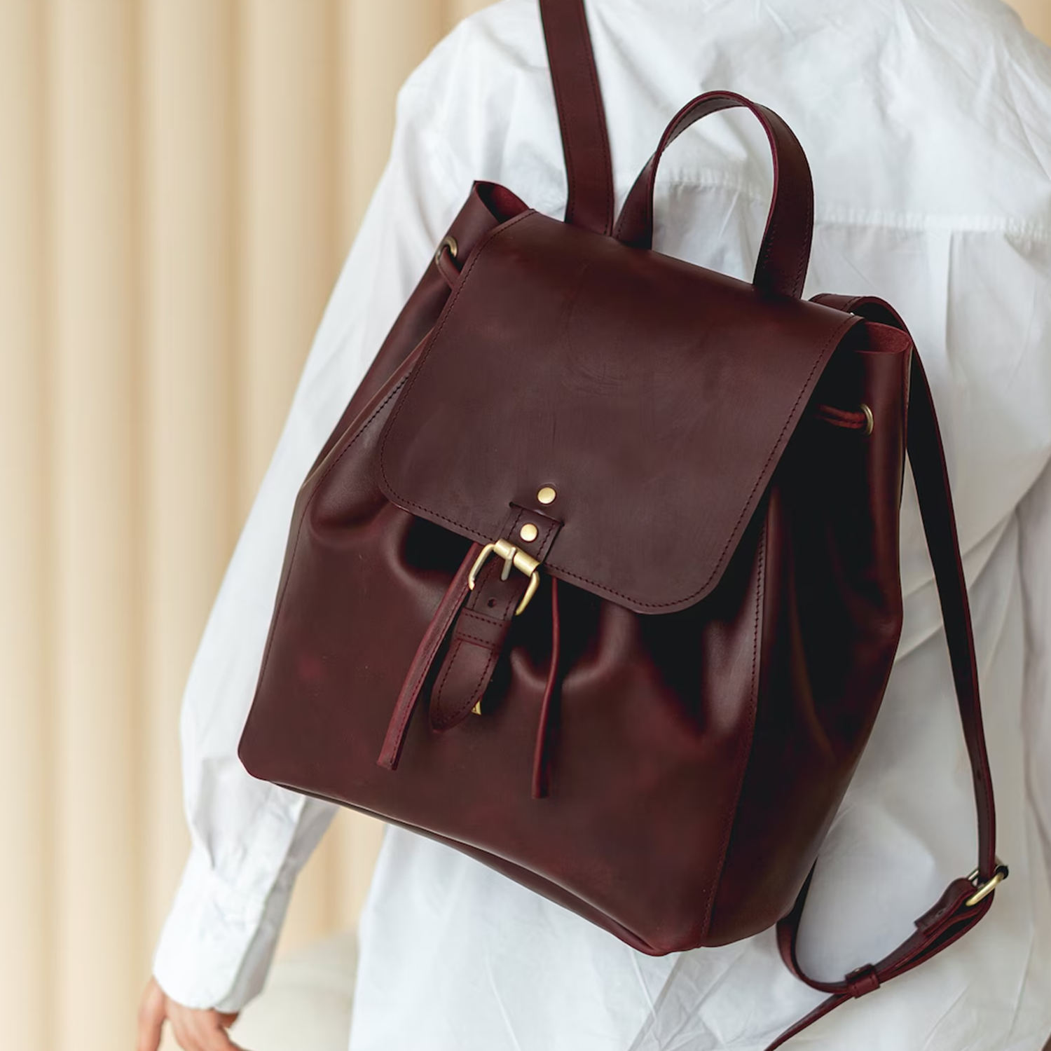 Deep Burgundy Smooth Grain Drawstring Bucket Haversack With Brass Buckle Flap Closure, Curved Top Handle And Adjustable Shoulder Straps